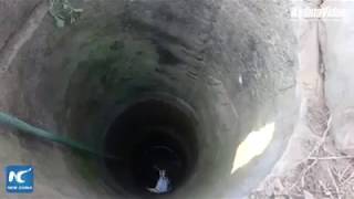 Firefighter hangs upside down to rescue elderly man trapped in deep well in Heze, China