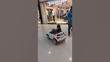 Kid driving car in a mall