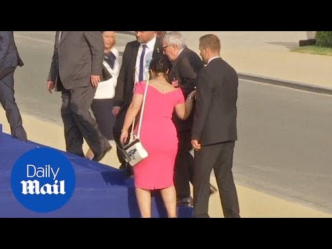 Jean-Claude Juncker stumbles and is helped by leaders at NATO gala