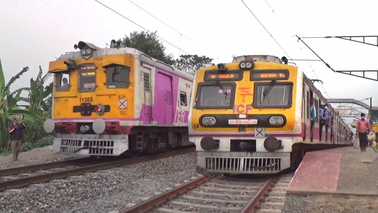 Different model 12 coach crowded local trains parallel crossing at Balagarh railway station