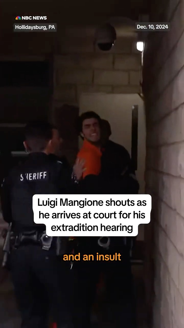 Luigi Mangione shouts as he arrives at court for his extradition hearing