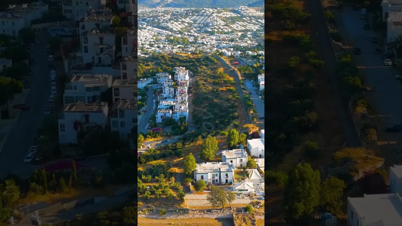 Vertical video. Bodrum, Turkey. Aerial view of Halicarnassus ancient city walls with white houses...