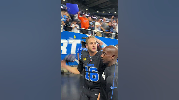 Lions quarterback Jared Goff tosses souvenirs to fans after win against Seahawks
