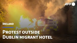 Irish protesters torch police van outside Dublin migrant hotel | AFP