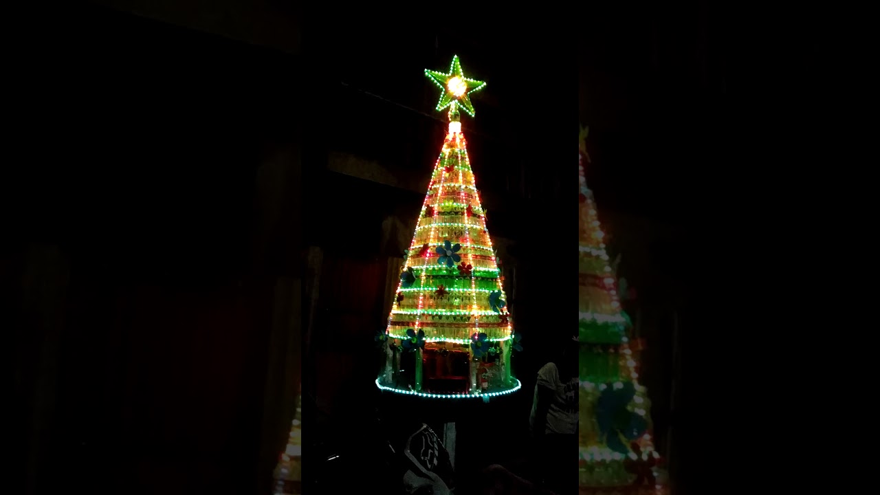 Christmas tree made by Coca Cola mismo bottles recycle materials