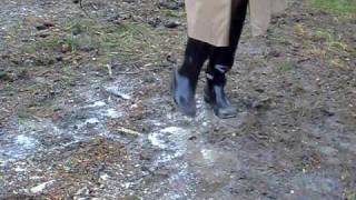 black rubber pvc boots in mud