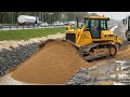 GOOD lUCK SHANTUI bulldozers have the power to push sand into the road foundation pit.