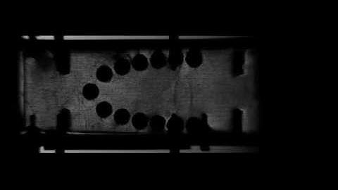 Schlieren Video of a Shock Wave Passing through a Logarithmic Spiral of Cylinders