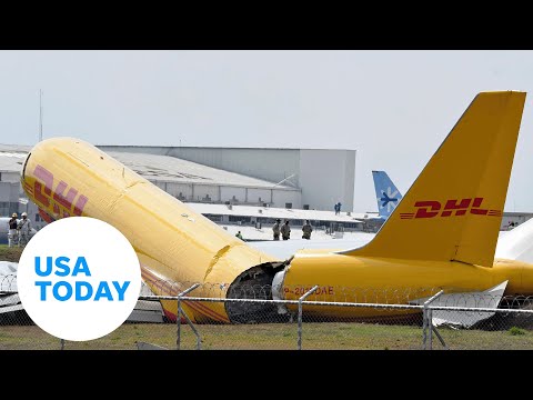 DHL cargo plane skids off runway, breaks in half during rough landing | USA TODAY