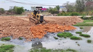 Operator Dozer Komatsu D20P & 5t garbage truck pushes the ground into the fields to make a house