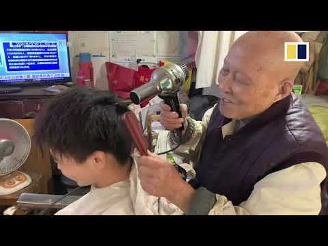 This Chinese barber uses a hot iron bar to cut hair