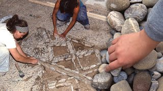 Cobbled floors. Craft drawing and placement of rounded stones in patios and churches