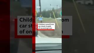 Two children saved from car stuck in path of oncoming train. #Train #US #BBCNews