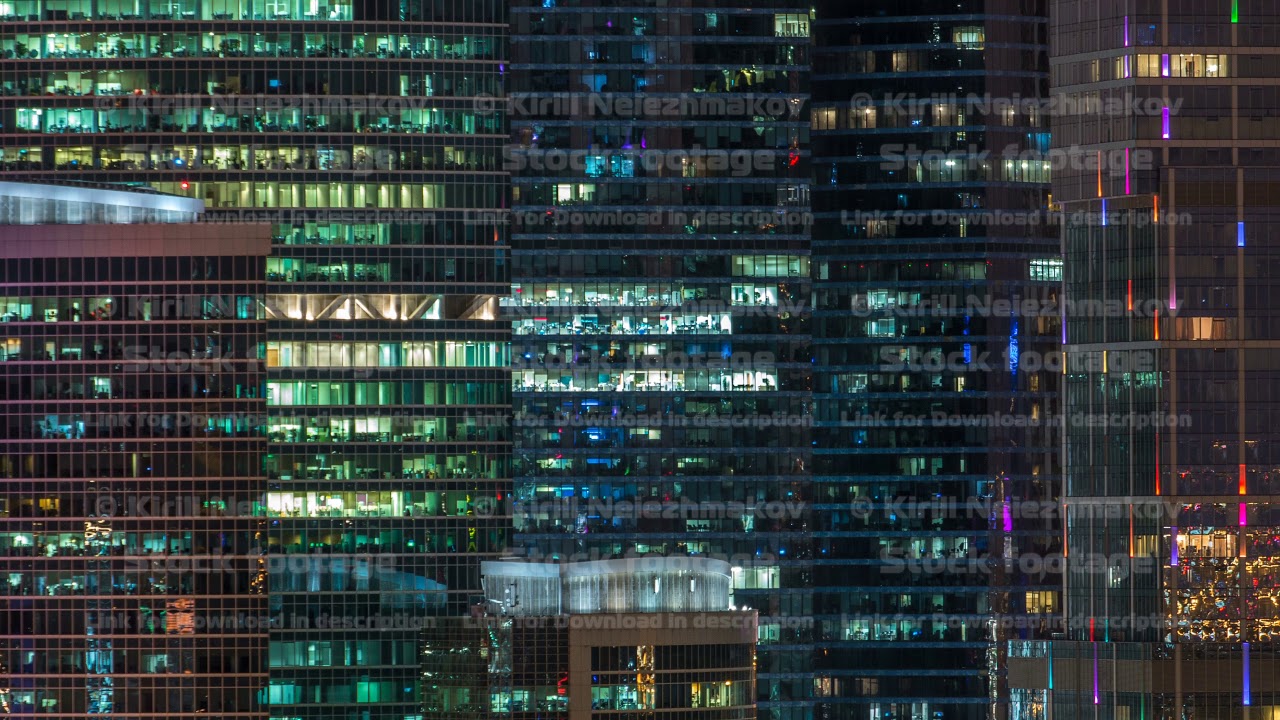 Modern office building with glowing windows at night timelapse. Moscow city