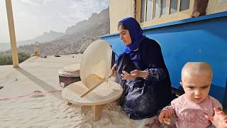 Local bread by nomadic woman and her child alone in the mountains