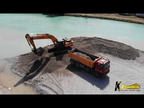 hyundai-320nlc-7a-excavator-loading-trucks-drone-view