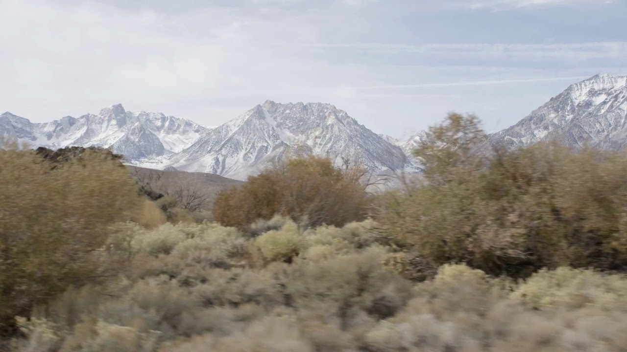 driving dolly pan of snowy mountains