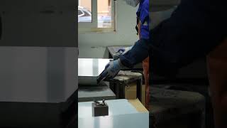 A worker is performing a polishing operation.