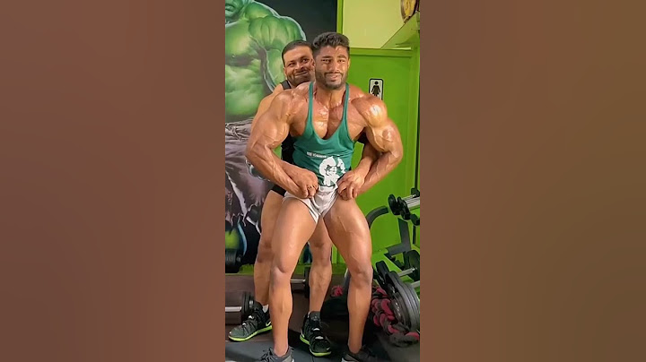 Bodybuilder helping partner flex to the max!
