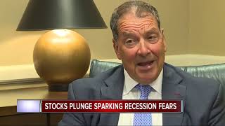 Dow tumbles 800 points after bond market flashes a recession warning