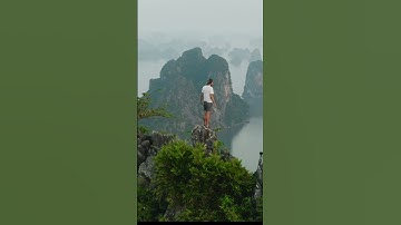man standing on a ridge looking out over Ha Long Bay, Beautiful Nature