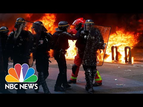 Paris police fire tear gas as May Day pension protests turn violent.