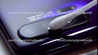Hand with a cotton swab to clean the smartphone camera.