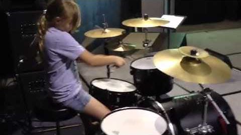 Emma learning paradiddles around the kit