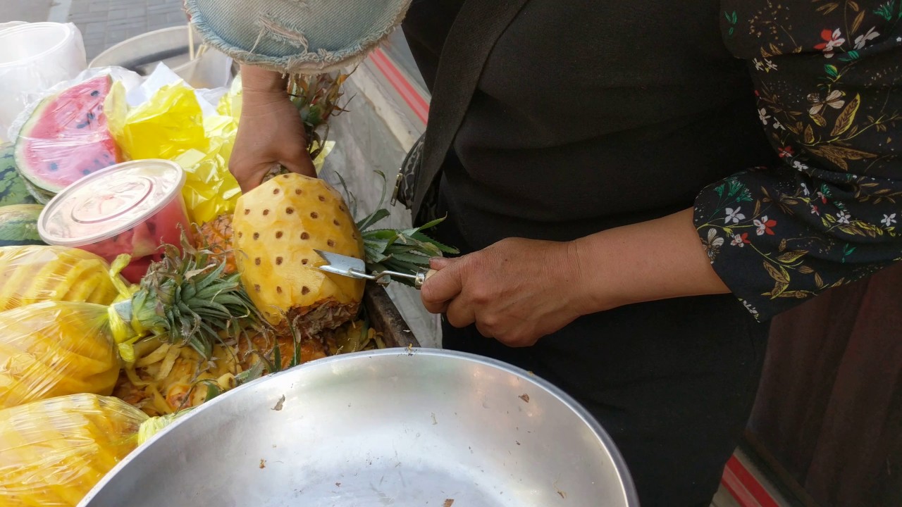 Clever way to cut a pineapple by a street vendor, Beijing, China, 2017