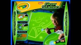 Crayola Glow Station (Crayola) TV Commercial - 2008
Crayola Glow Station (Crayola) - 2008
Dates and Regional Names:
- North America: Fall 2008 (Mass retail rollout)
- Global: Late 2008
Platforms:
Arts & Crafts Aisles / Toy Retailers
Publisher:
Crayola LLC / Binney & Smith
Developer:
Crayola Innovation and Development Team
Type:
Glow-in-the-Dark Light Drawing Canvas
Media:
Phosphorescent Portable Hanging Banner with Handheld UV Light Wand
Description and Experience:
The Crayola Glow Station is a specialized, mess-free artistic playset released by Crayola in the fall of 2008. Centered around a large, rollable phosphorescent green canvas banner, the toy allows children to sketch and design using a battery-powered ultraviolet light wand rather than traditional markers or ink. When used in a darkened room, the canvas immediately illuminates with high-contrast neon green brushstrokes wherever the light beam hits. The illustrations remain brightly visible for roughly 30 seconds to a minute before organically fading away, resetting the canvas for non-stop, repeatable creation.
Key Features:
- Large phosphorescent canvas sheet designed to hang easily on bedroom walls or spread out on floors
- Dual-mode handheld light wand with standard drawing beams and wide-angle floodlight settings
- Two included pattern texture sheets for stamping starry night sky overlays and geometric shapes
- Over 10 custom reusable stencil cutouts featuring rocket ships, alien creatures, and animal borders
- Completely mess-free layout requiring no ink, paper refills, or clean-up cycles for parents
Technical Specifications:
- High-grade durable plastic framing structure housing a roll-up vinyl canvas backing
- Built-in accessory storage hooks and wand holsters integrated directly into the top console bar
- Requires 3 AAA consumer batteries housed inside the light wand to power the UV LED bulb
- Integrated high-persistence luminescent crystal coatings optimized for maximum low-light retention
Advertising Description (North America):
Turn off the lights and turn on the fun! Introducing the all-new Glow Station from Crayola! Now you have the power to create amazing illustrations with light! Just use the special light wand to draw glowing pictures right on the magic canvas. Use stencils to paint a universe, or use the texture sheets to create incredible glowing patterns! When youre done, watch your drawings fade away so you can start all over again! Real creativity, zero mess. Get the Crayola Glow Station today! Batteries not included, from Crayola.
Additional Details:
- Age Range: Recommended for children and creative youth ages 6 years and older
- Best for: Aspiring young artists, nighttime bedroom playrooms, and nostalgic 2000s toy collectors
Historical Context:
Launched ahead of the 2008 holiday shopping season, the Glow Station served as a major flagship product for Crayolas high-tech 64 Days of Crayola national marketing push. Developed to compete against traditional digital drawing tablets and video games, it successfully merged tactile arts-and-crafts play with the novelty of light-up technology. The product was a critical hit, receiving FamilyFun magazines prestigious Toy of the Year (T.O.Y.) Award upon its launch. Its commercial footprint paved the way for subsequent successful expansions, including the portable Glow Station On-The-Go and the enhanced Glow Station Day & Night supersets.
Did You Know?
- The underlying science utilizes persistent photoluminescence, where the canvas crystals temporarily store and slowly discharge energy absorbed from the light wands UV spectrum.
- Crayola actively marketed the toy to parents as an ideal travel companion because children could draw silently in the backseat of cars during night drives without creating any mess.
- The television commercial featured a memorable ambient, bass-heavy background jingle that emphasized the transition from a brightly lit room to a pitch-black drawing environment.
- Because ambient indoor light can accidentally charge the board, the canvas retains a soft, ghostly green glow even when it hasnt been directly sketched on.
- Mint-condition, unopened boxes from the original 2008 manufacturing run are considered rare collectibles and regularly pop up on vintage trading spaces like eBay.
🎨🌌🔦✨ Crayola Glow Station (Crayola) TV Commercial - 2008