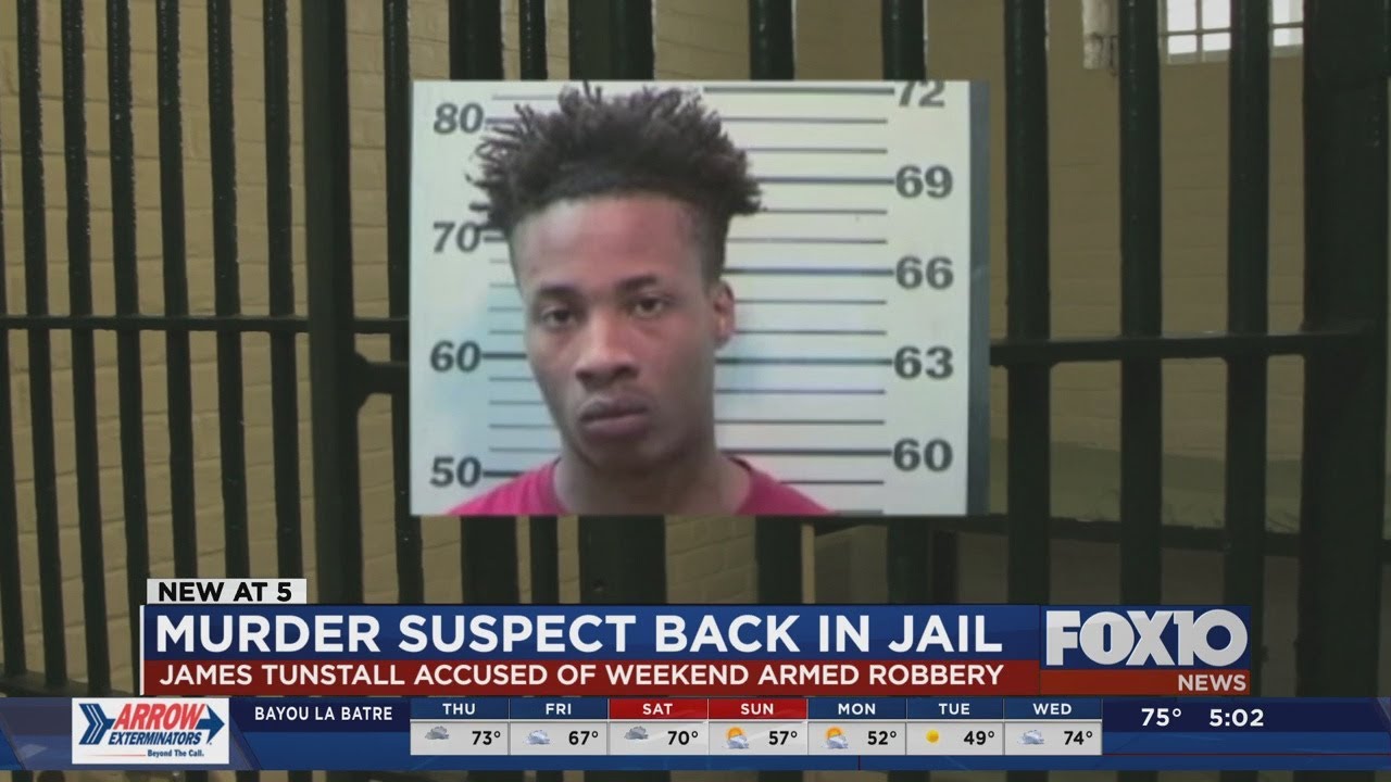 Murder suspect out on bond charged with robbery - YouTube