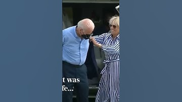 Jeo Biden struggles to get his jacket on before dropping sunglasses