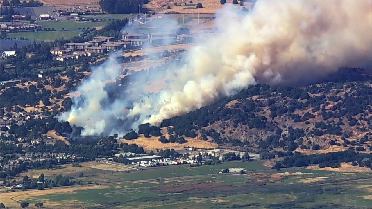Crews battling brush fire burning near homes in California - YouTube
