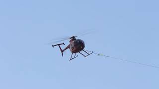 Helicopter Strings Power Lines Across Red River