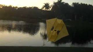 Bring my homemade winged box kite in for a landing over a lake with very light wind. Plans online, easy to make and fly.