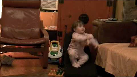 Lola bouncing on recliner