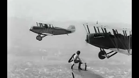 Gladys Ingle climbs from one plane to another to change out a faulty tire in mid-air, 1926