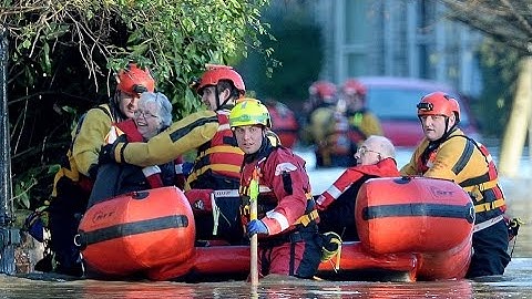 Incredible Aerial pictures show city almost completely underwater more heavy rain and 70mph