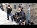 London Street Music. Harmonica Player and Drummer Performing in Brick Lane