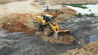 Wheel loader plowing dirt road connecting - សាស័ររុញដី​ ឡានបែនចាក់ដី