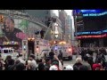 NYPD removes guy from light pole in Times Square