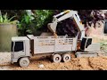 Remote control truck and excavator work sand digging-construction action. from grey cardboard paper.