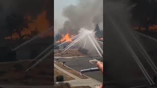 Automatic sprinklers in action as wildfires approach residential areas #wildfire #climatechange