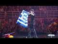 Enrique iglesias with the greek flag on stage