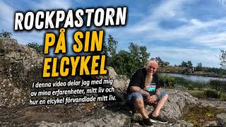 Rockpastorn på sin elcykel