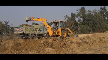 Jcb Backhoe machine loading soil in Heavy Truck