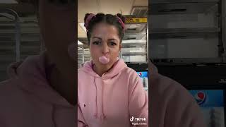 Cute woman blows big bubblegum bubbles