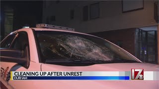 Businesses and other clean up in Durham after damage following protests