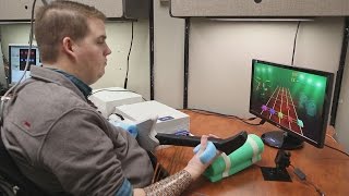 Brain chip implant helps paralyzed man regain control of hand
