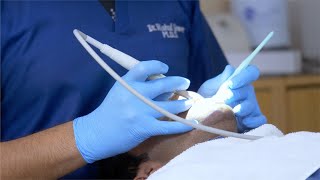 Video of an endodontist / dental doctor treating his patient with an assistant